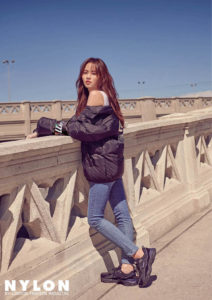 Young woman in stylish puffer jacket outdoors.