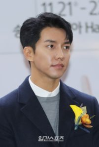 Man in formal attire with a flower boutonniere.