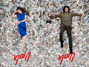Two characters lying amidst scattered photographs.