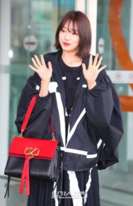 Person in stylish black and red outfit.