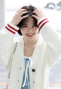 Smiling person with short hair and sweater.