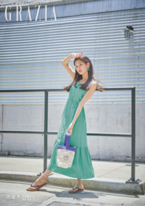 Woman in green dress striking a pose.