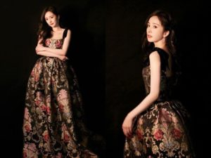 Elegant woman in floral evening gown.