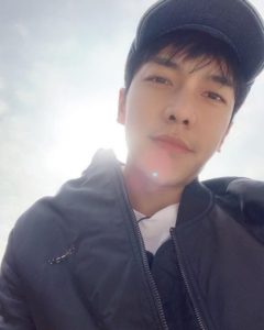 Young man taking a selfie outdoors.