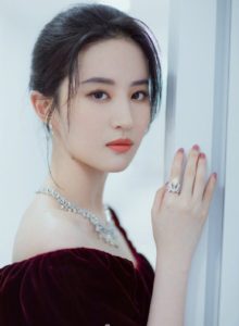 Elegant woman in a jewel-toned dress.