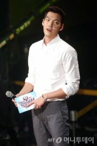 Young man holding a microphone and card.