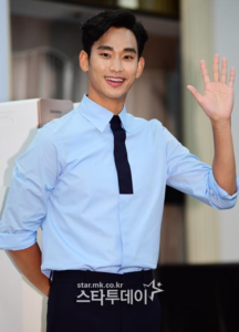 Smiling man in a light blue shirt.
