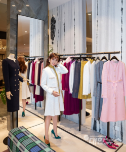 Woman modeling stylish clothes in boutique.