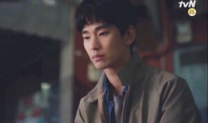 Young man with a serious expression indoors.