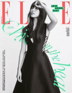 Model in black dress on magazine cover.