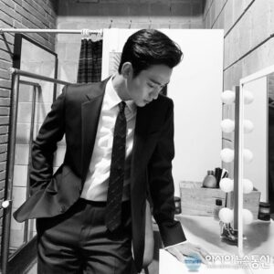 Man in suit posing in a stylish bathroom.