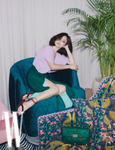 Woman in stylish attire lounging on a chair.