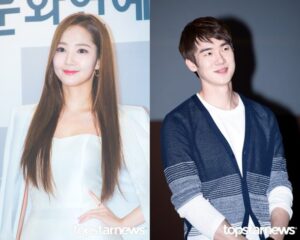 Two smiling individuals at an event.