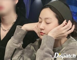 Person with closed eyes resting hands on face.