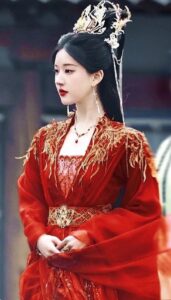 Woman in ornate red traditional attire.