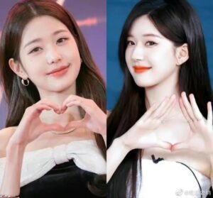 Two women making heart shapes with hands.