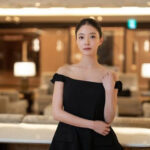 Woman in a black dress, elegant setting.