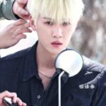 Person with blonde hair sitting on motorcycle.