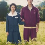 Man and woman standing in a field.