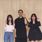 Three people posing with raised fists.