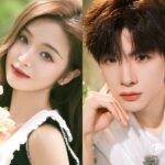 Woman and man posing with flowers.