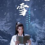 Man reading book in snowy landscape.