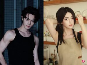 Man in black tank top, woman adjusting hair.