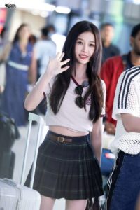 Person waving while standing at airport.