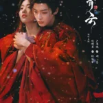 Couple in red robes with snowflakes falling.