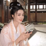 Woman in traditional attire using smartphone.