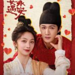 Couple in traditional attire with heart designs.