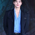 Man in blue shirt and black jacket.