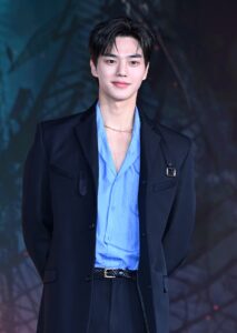 Man in blue shirt and black jacket.