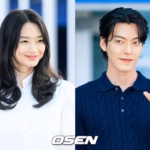 Man and woman smiling, wearing casual outfits.