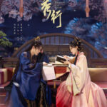Two people in traditional Chinese costumes reading